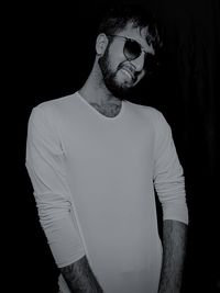 Man standing against black background
