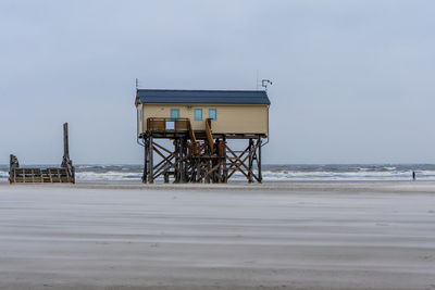 Lifeguard hut on beach against clear sky