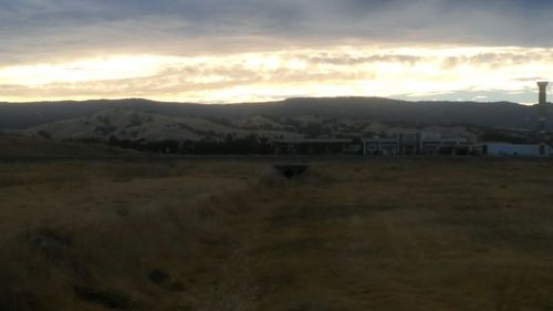 Scenic view of landscape against cloudy sky