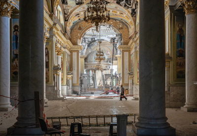 Rear view of man standing in historic building