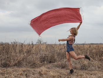 Full length of woman on landscape against sky