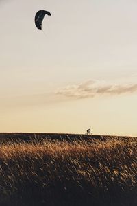 Parachute over scenic field against sky