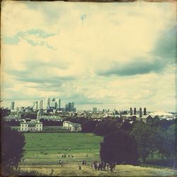 View of cityscape against cloudy sky