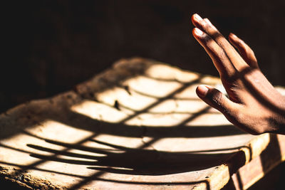 Close-up of hand on wooden table