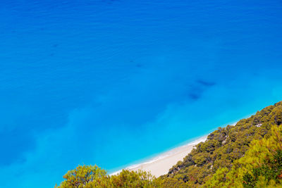 High angle view of sea against blue sky