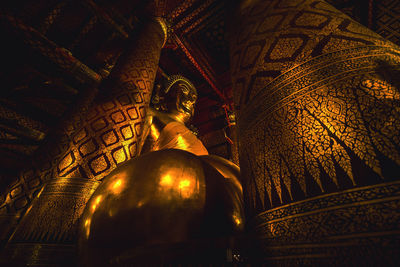 Low angle view of statue against illuminated building