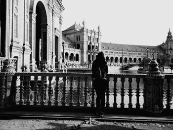 Full length of man and woman standing in front of historical building