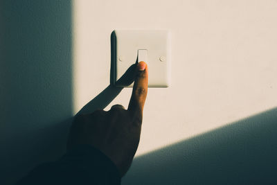 Close-up of hand on wall