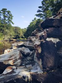 Rocks on landscape against sky