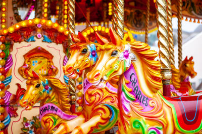 Close-up of brightly coloured fairground carousel horses
