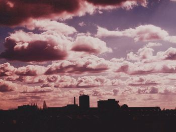 Cityscape against cloudy sky