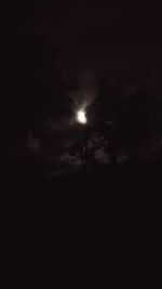 Low angle view of silhouette moon against sky at night