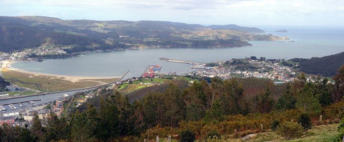 High angle view of townscape by sea against sky