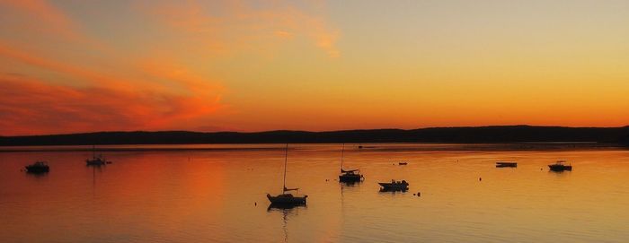 Scenic view of lake against orange sky