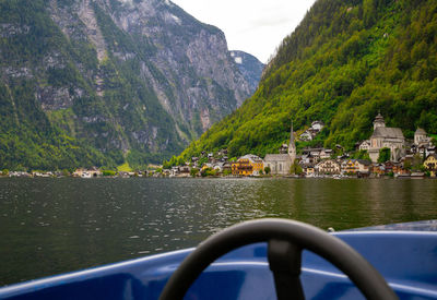 Scenic view of lake by buildings against mountains