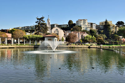 Fountain in park against clear sky