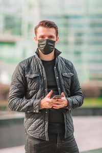 Portrait of young man using mobile phone