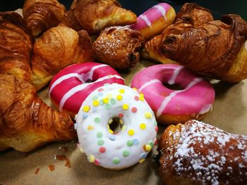 Close-up of croissant and donuts on table