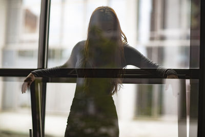 Woman looking through window