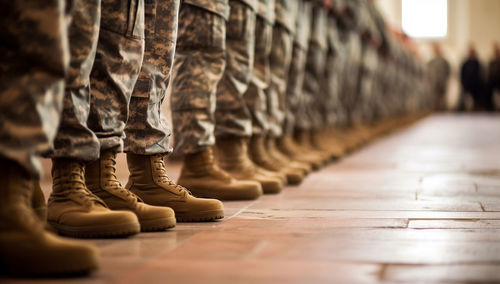 Low section of man standing on hardwood floor