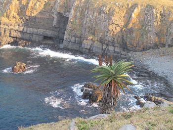 Scenic view of sea by rock formation