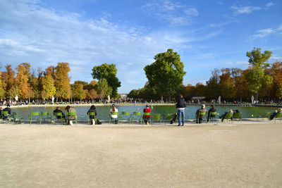 Group of people at park against sky