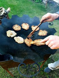 High angle view of people preparing food on barbecue grill