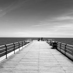 Pier over sea against sky