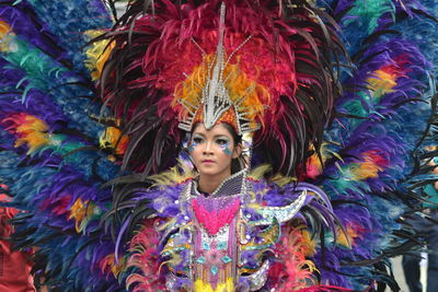 Portrait of serious young woman wearing colorful costume