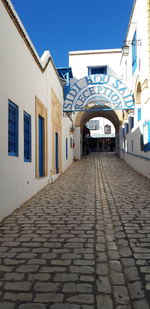 Empty alley amidst buildings in city