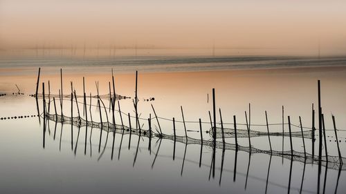 Scenic view of lake against sky during sunset