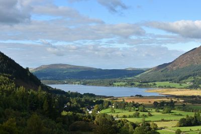 Scenic view of lake and mountains against sky