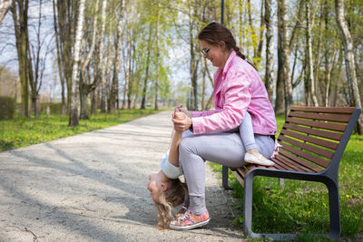 Side view of man sitting on road