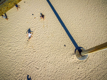 High angle view of men walking on sand