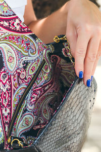 Girl holding a bag made of handmade python skin