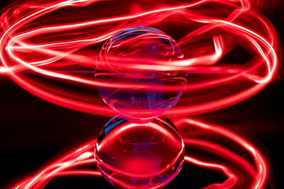 Abstract image of illuminated red light against black background