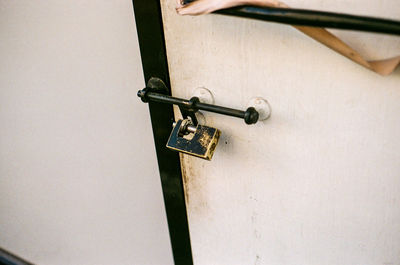 Close-up of padlock on white door