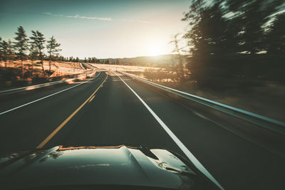 High angle view of light trails on highway against sky during sunset