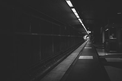 Man on illuminated underground walkway