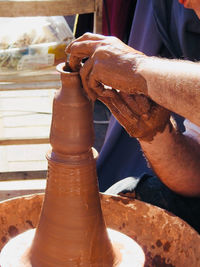 Close-up of human hand in mud