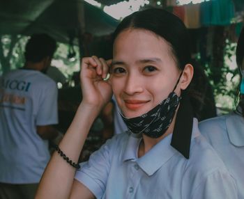 Portrait of young woman in city