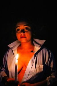 Portrait of man against black background