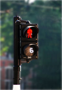 Close-up of road signal against blurred background