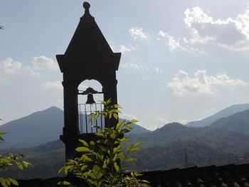 Low angle view of bell tower against sky