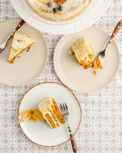 Pieces of carrot cake served on plates. top view, portrait orientation 