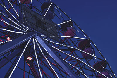 Illuminated evening light wheel with colored lights in lecco city