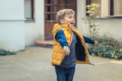 Smiling boy walking on footpath