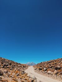 Scenic view of mountains against clear blue sky