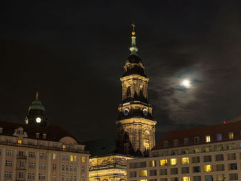 Low angle view of illuminated buildings against sky at night