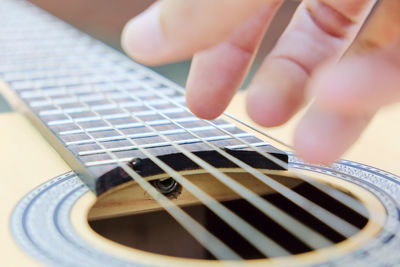 Cropped image of man playing guitar